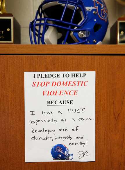 South Garland's head football coach Josh Ragsdale pledge against domestic violence in his...