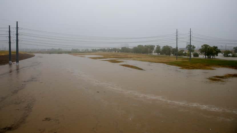 The Trinity River rises over its banks near the Margaret Hunt Hill Bridge in Dallas, Monday,...