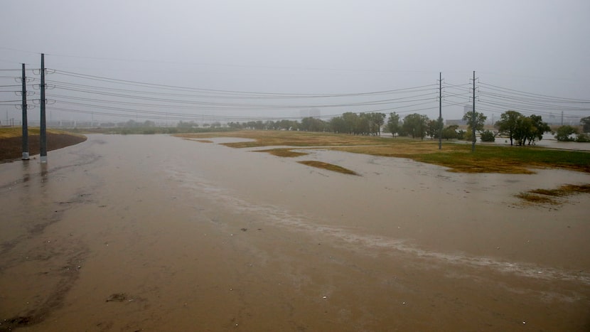 The Trinity River rises over its banks near the Margaret Hunt Hill Bridge in Dallas, Monday,...