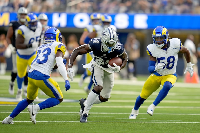 Dallas Cowboys wide receiver Kelvin Harmon (84) gains yards after a catch as Los Angeles...