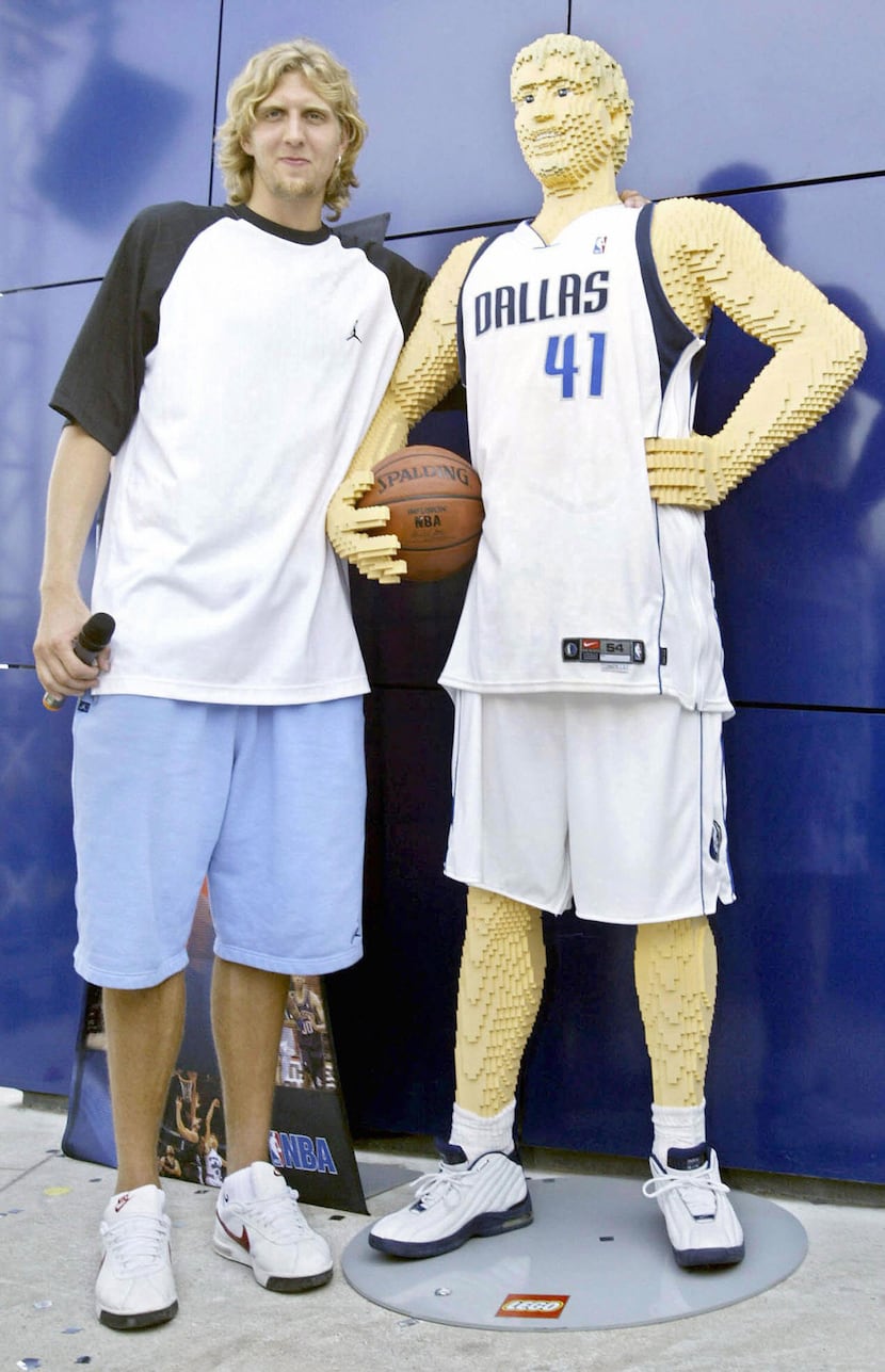 German NBA player Dirk Nowitzki stands next to a statue of himself made of Lego bricks in...