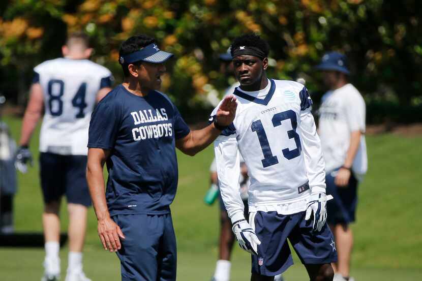Dallas Cowboys wide receivers coach Sanjay Lal talks to receiver Michael Gallup (13)  during...