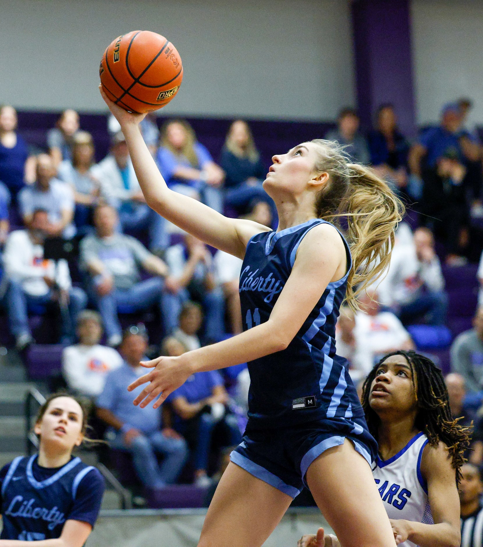 Argyle Liberty Christian guard Lauren Ullrich (11) attempts a layup during the second half...