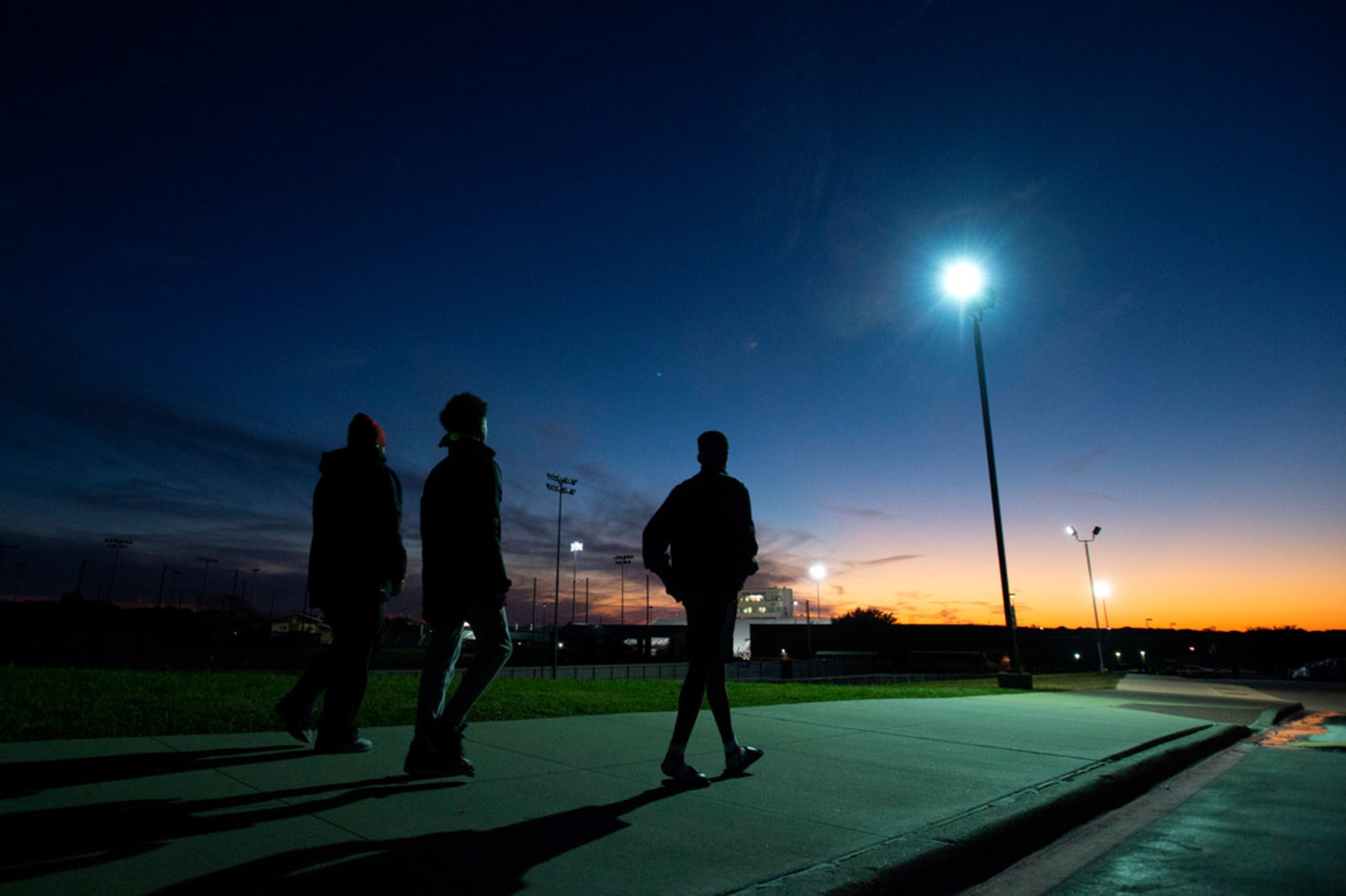 Hebron fans walk towards Hawk Stadium before a high school football game against Irving...