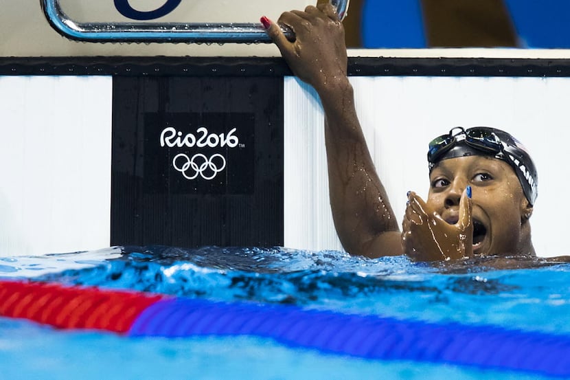 Simone Manuel of the USA reacts after swimming to the gold medal in the women's 100m...