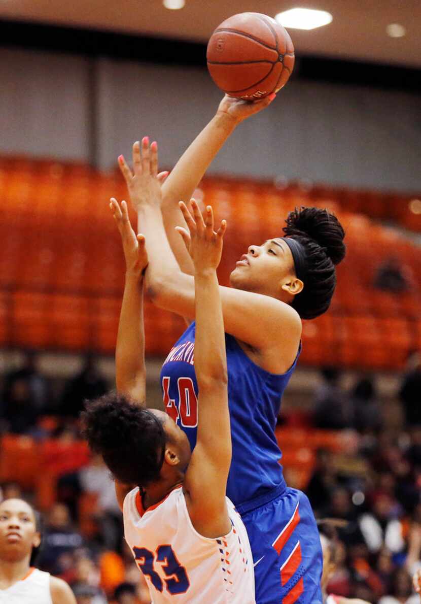 Duncanville's Hannah Gusters (40) attempts a shot against Arlington Bowie on February 23,...