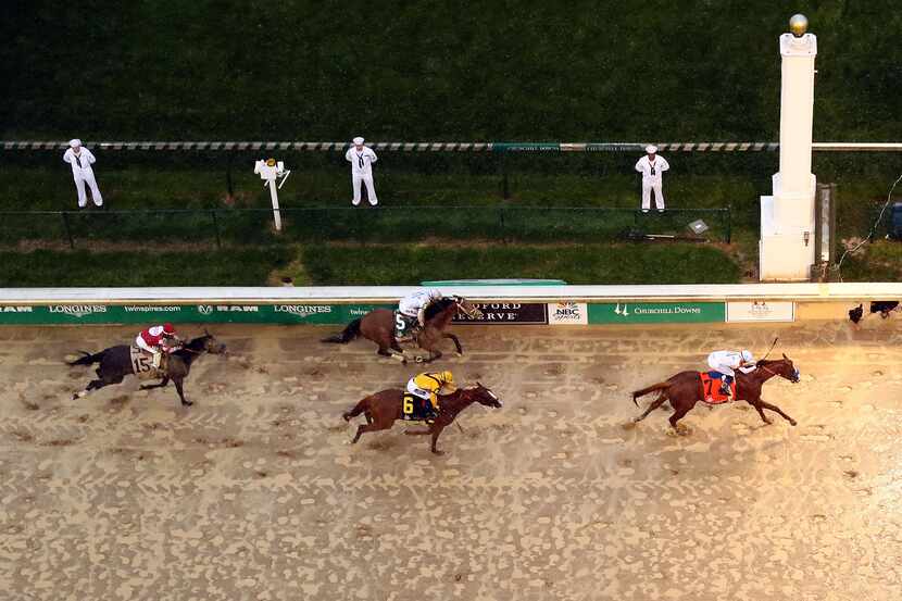 Justify, ridden by jockey Mike Smith, crosses the finish line to win the 144th running of...