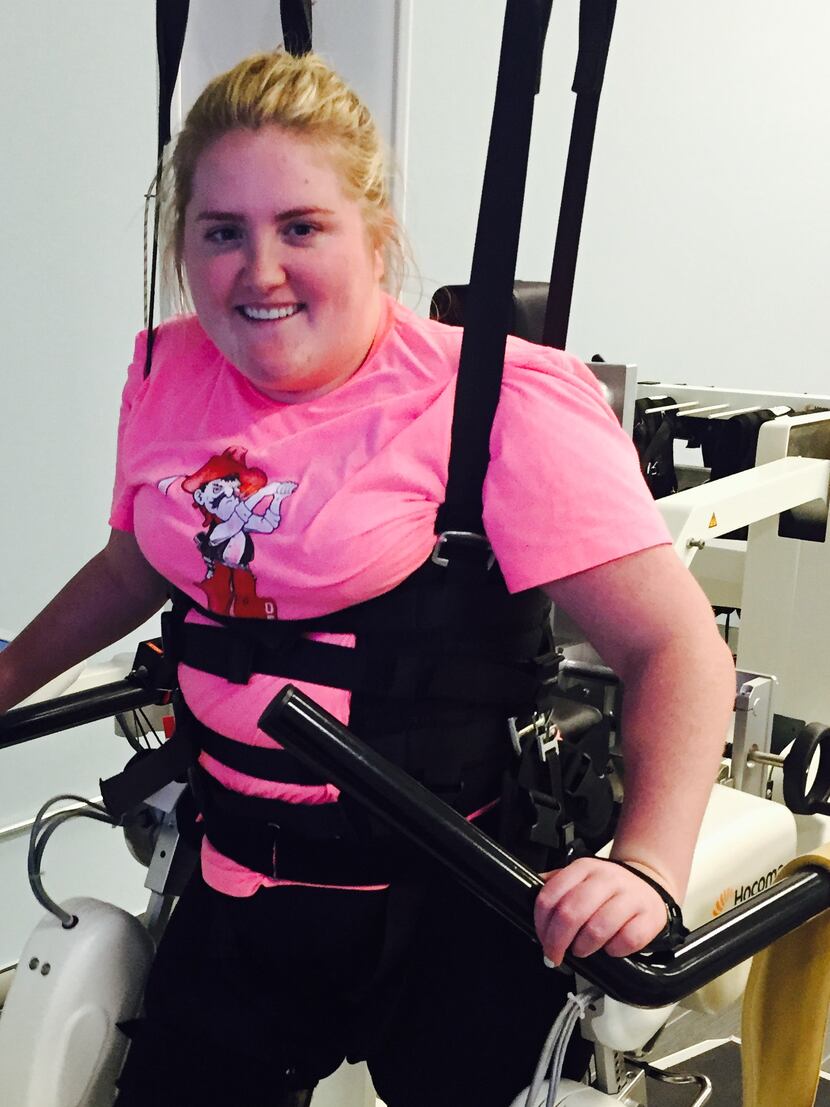 Sarah Milburn, 24, at physical therapy. She was paralyzed after the Uber van she was riding...