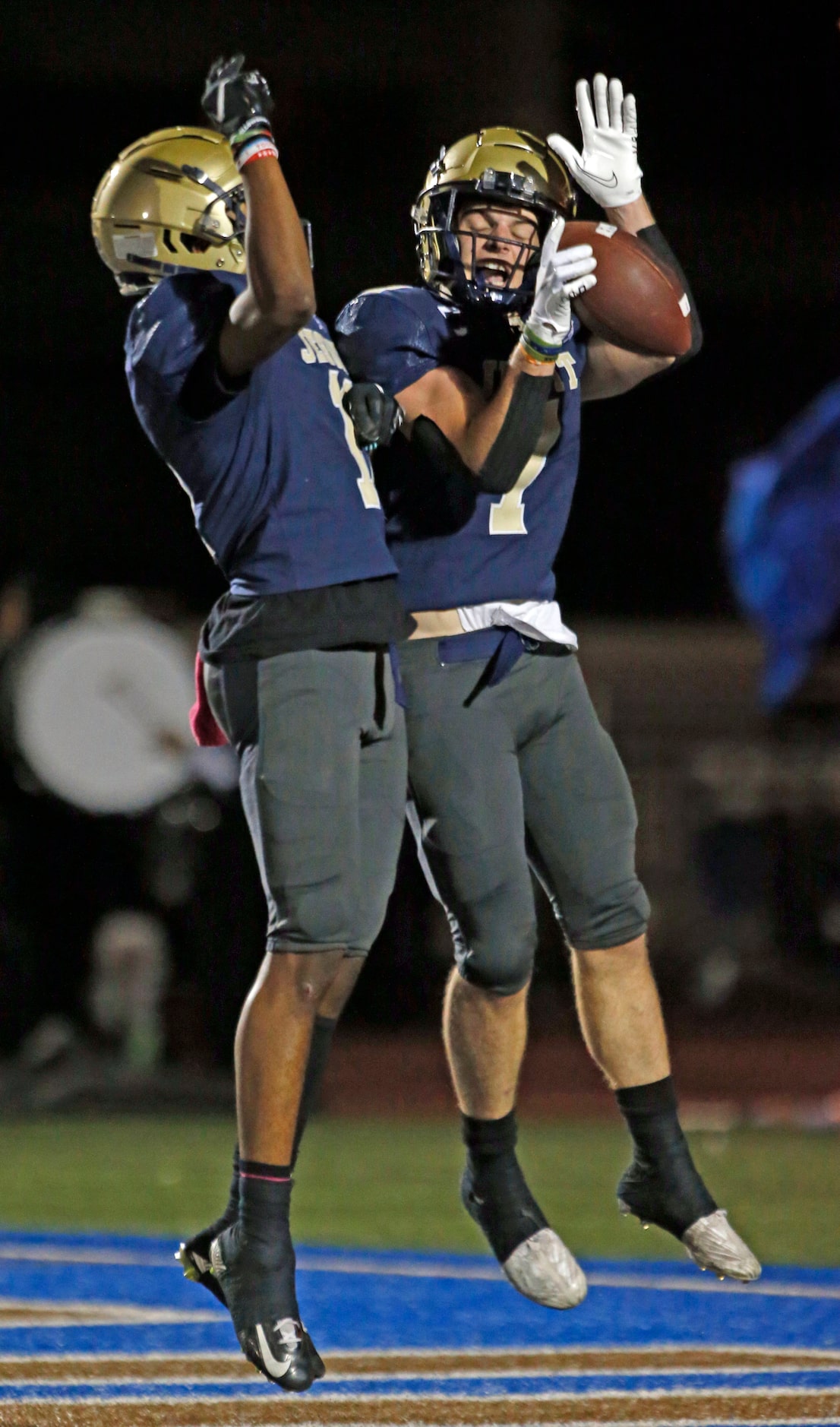 Jesuit Jake Musso (7, right) celebrates with a teammate after grabbing a touchdown catch...