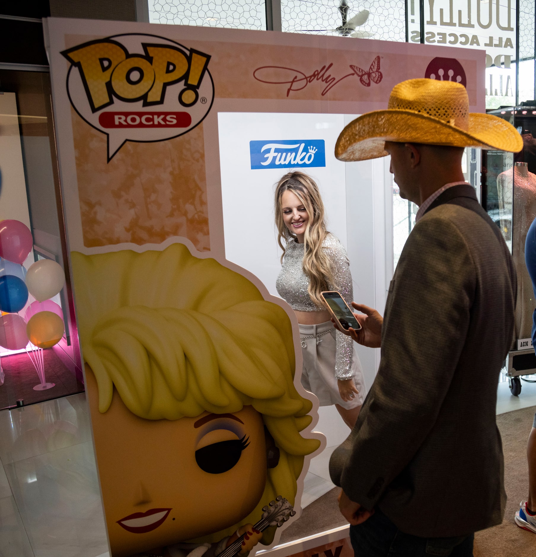 Denae Beedlow of Decatur poses for photos in the Funko Pop! box at the Dolly Parton pop-up...