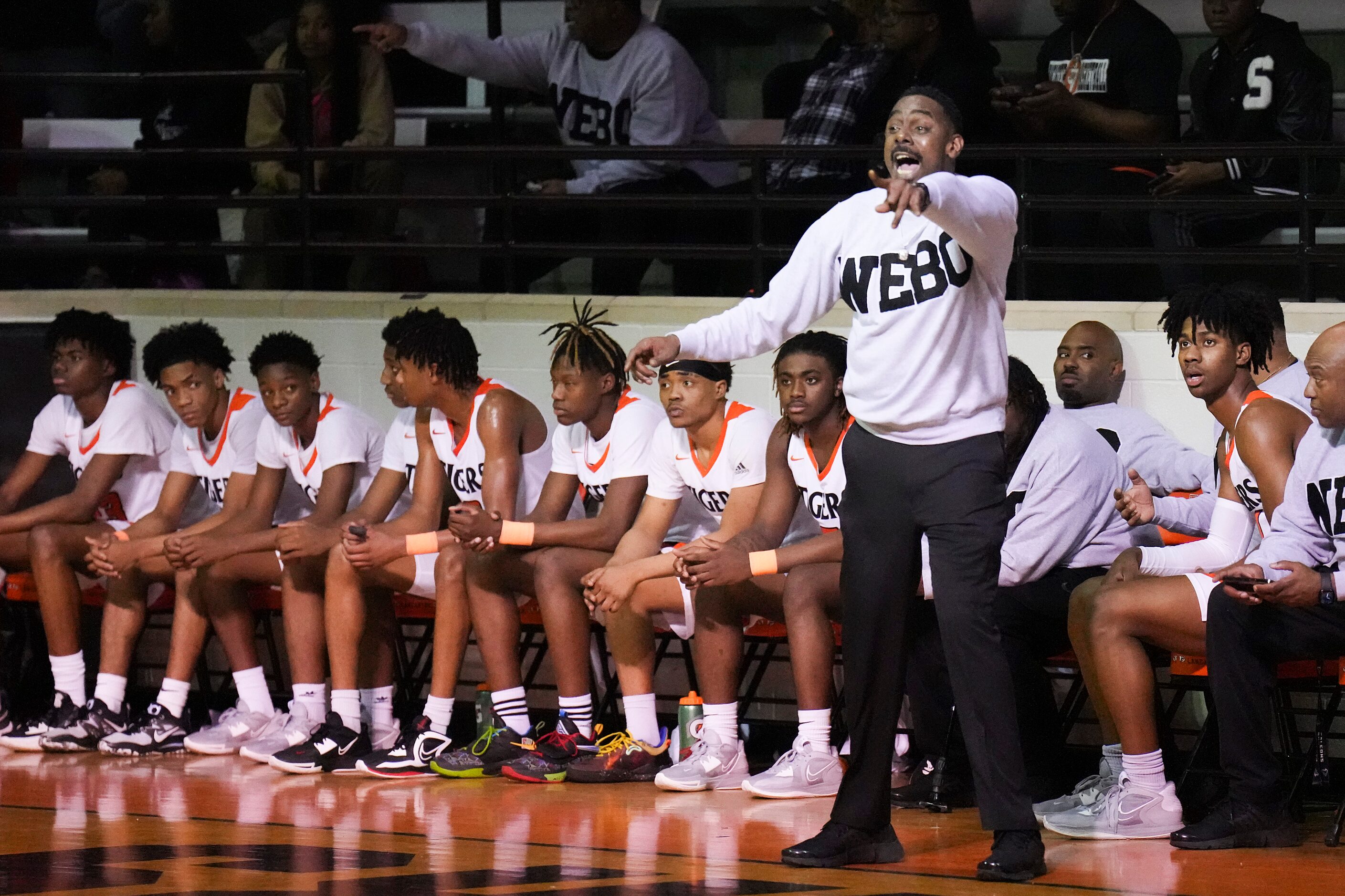 Lancaster head coach Ferrin Douglas directs his team during a boys high school basketball...