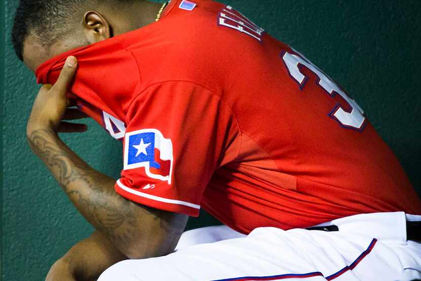 Texas Rangers relief pitcher Neftali Feliz sits in the dugout after giving up three runs in...