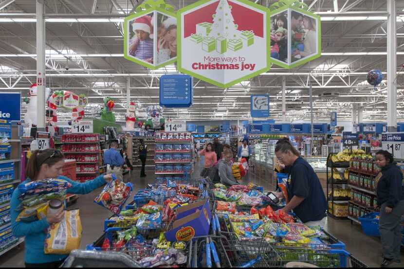 Wal-Mart customers sort through marked-down items at the store at Northwest Highway and...