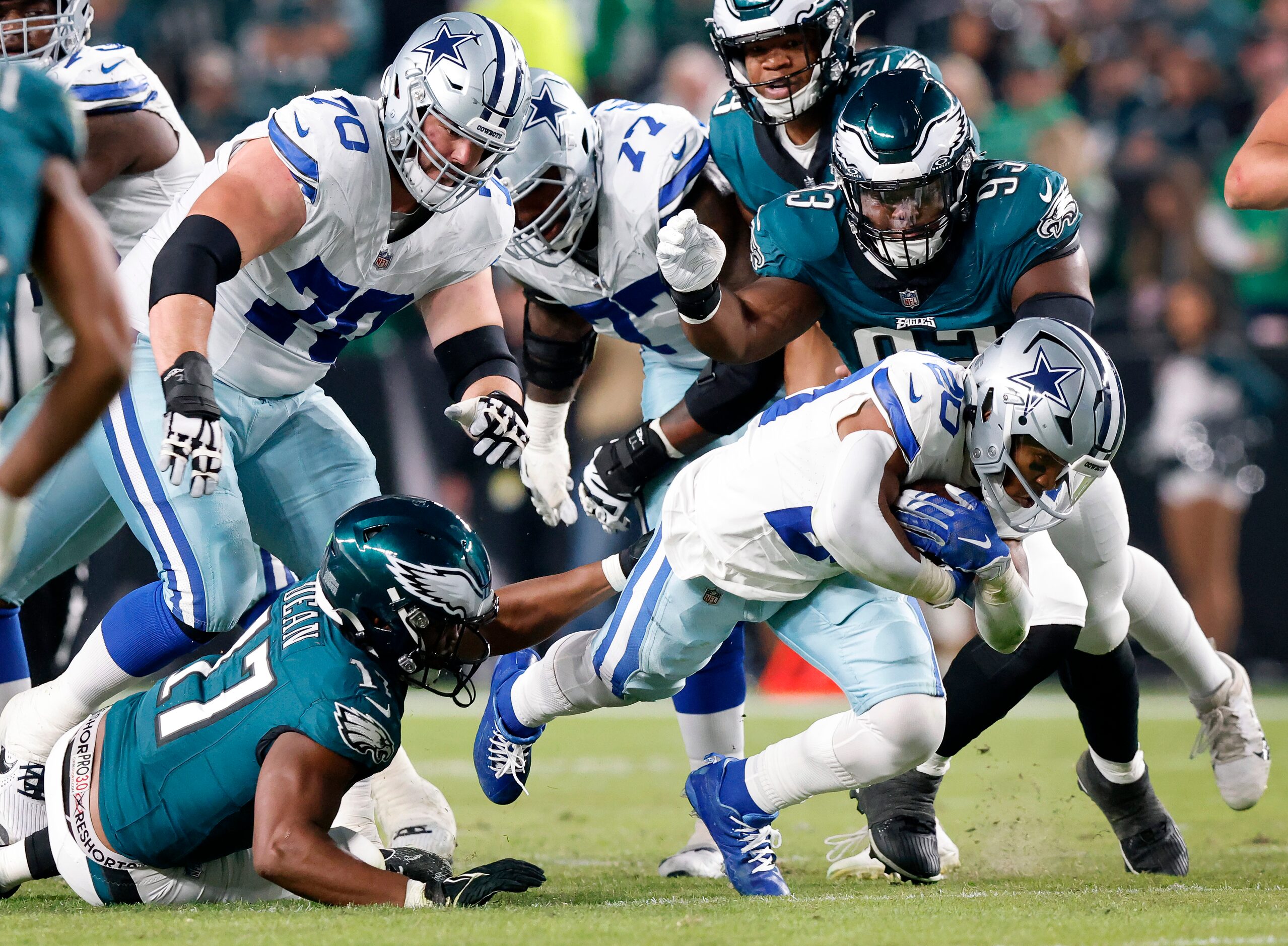 Dallas Cowboys running back Tony Pollard (20) plows ahead for more yardage against the...