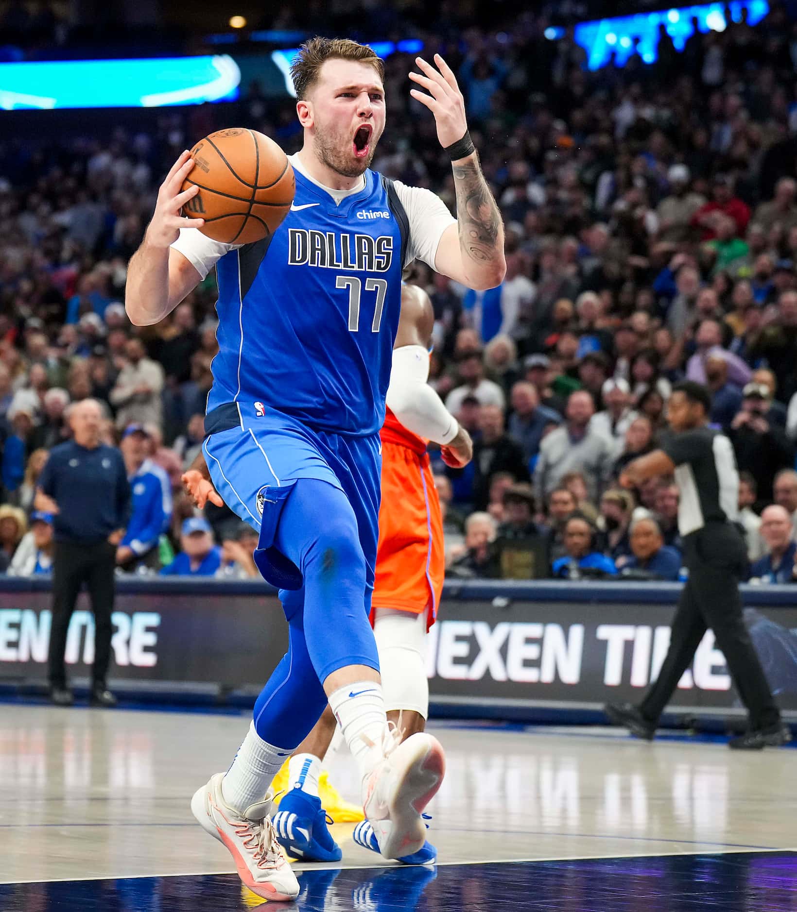 Dallas Mavericks guard Luka Doncic reacts after being called for traveling with 1:27 left in...