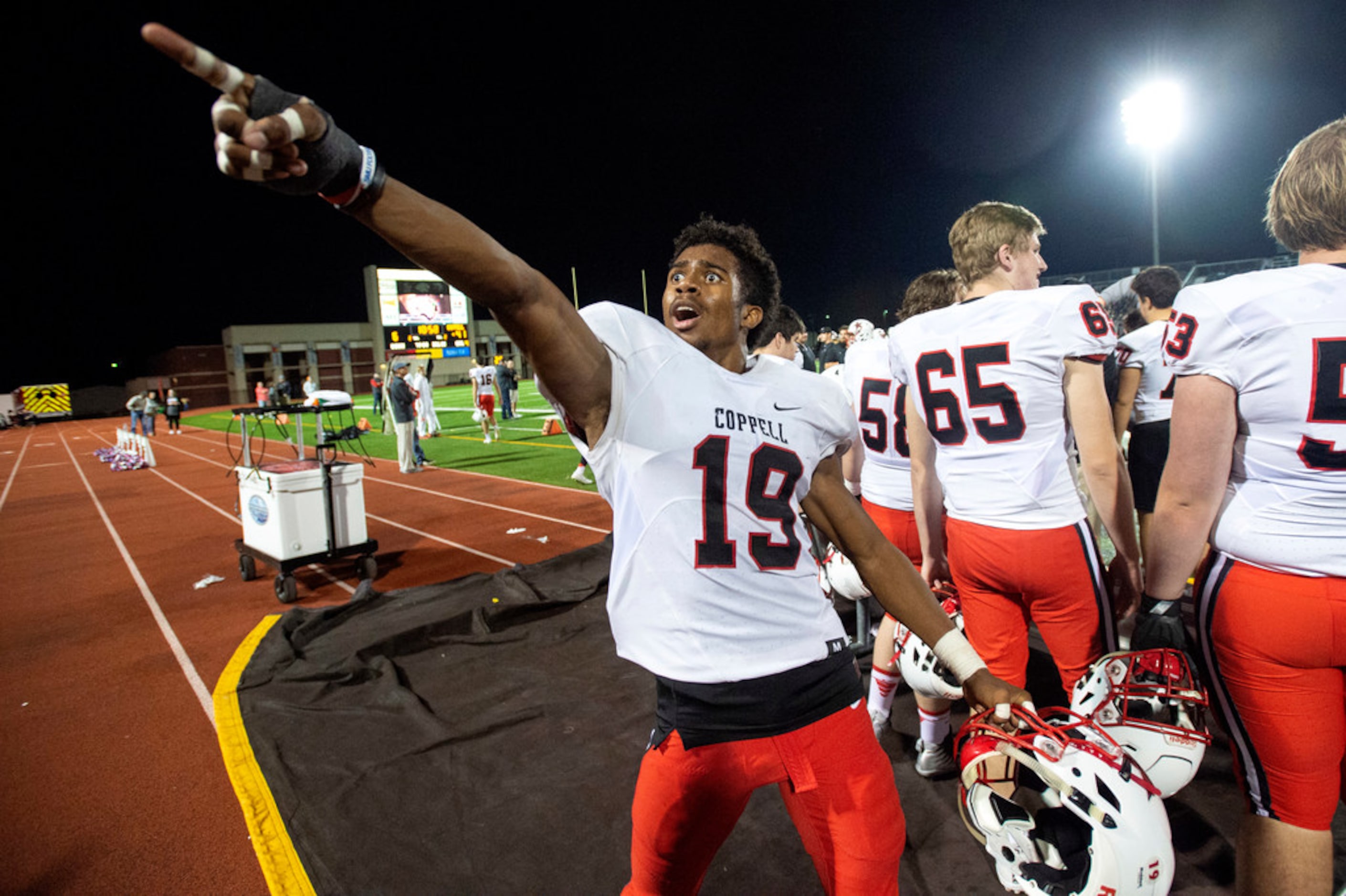 Coppell senior linebacker Xavier Brown (19) points to the crowd during the second half of a...