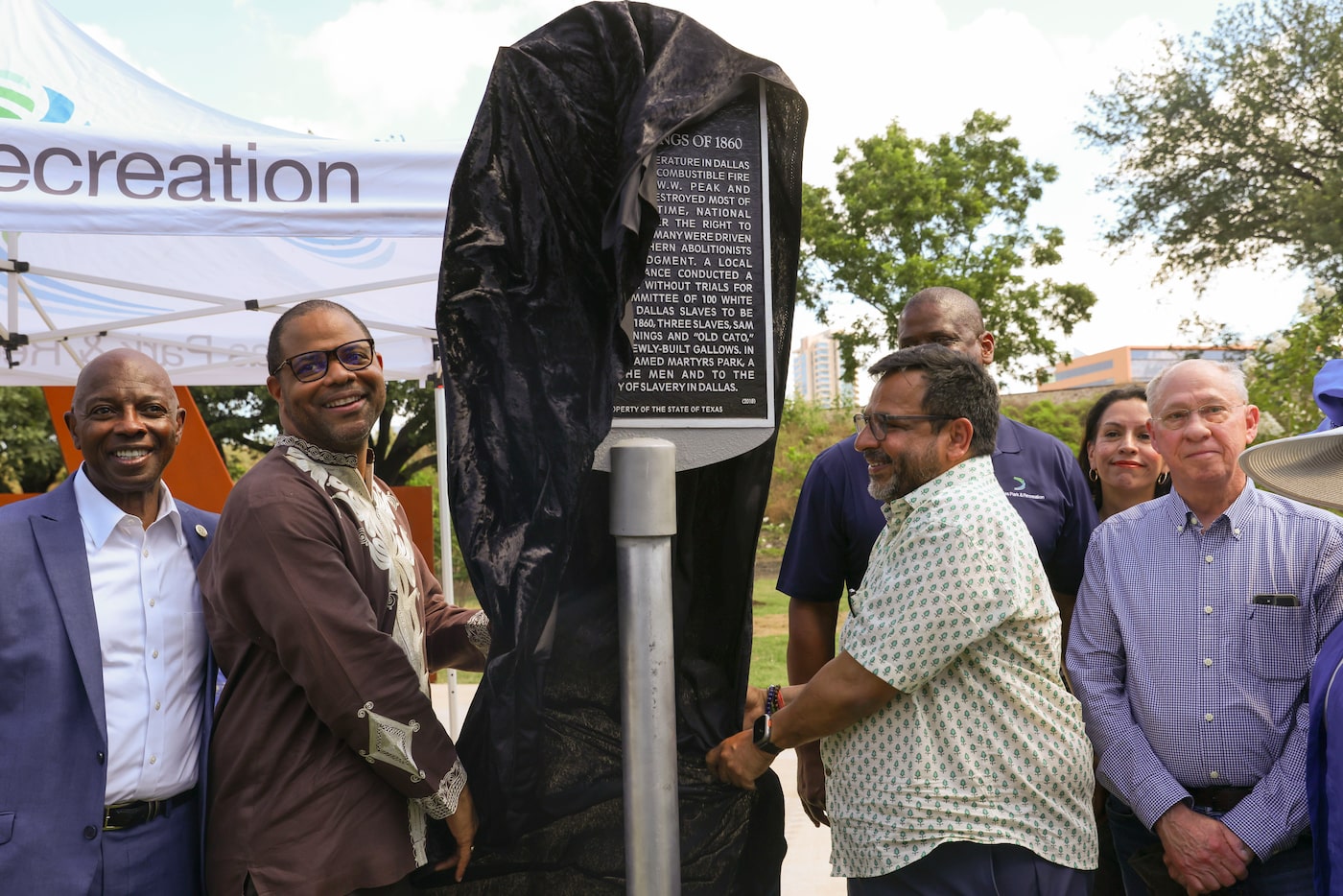 Dallas Mayor Pro Tem Tennell Atkins (left), Dallas Mayor Eric Johnson (center left), and...