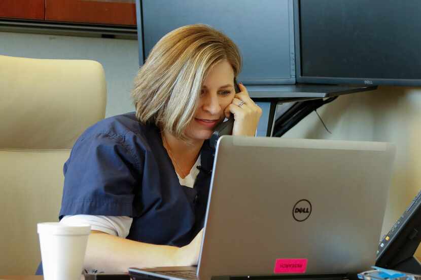 Kristin Posey Wallis, uterus transplant nurse, works to return phone calls to interested...