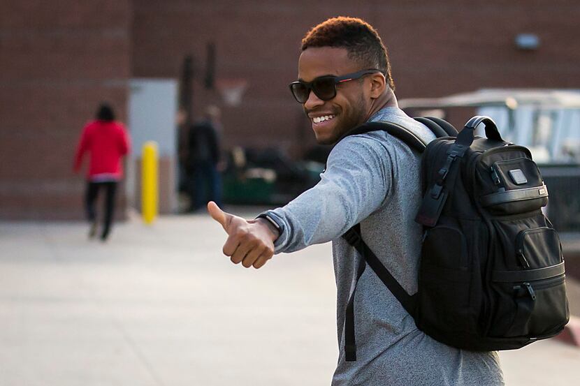 Texas Rangers outfielder Delino DeShields gives a thumbs up as he heads to the clubhouse on...