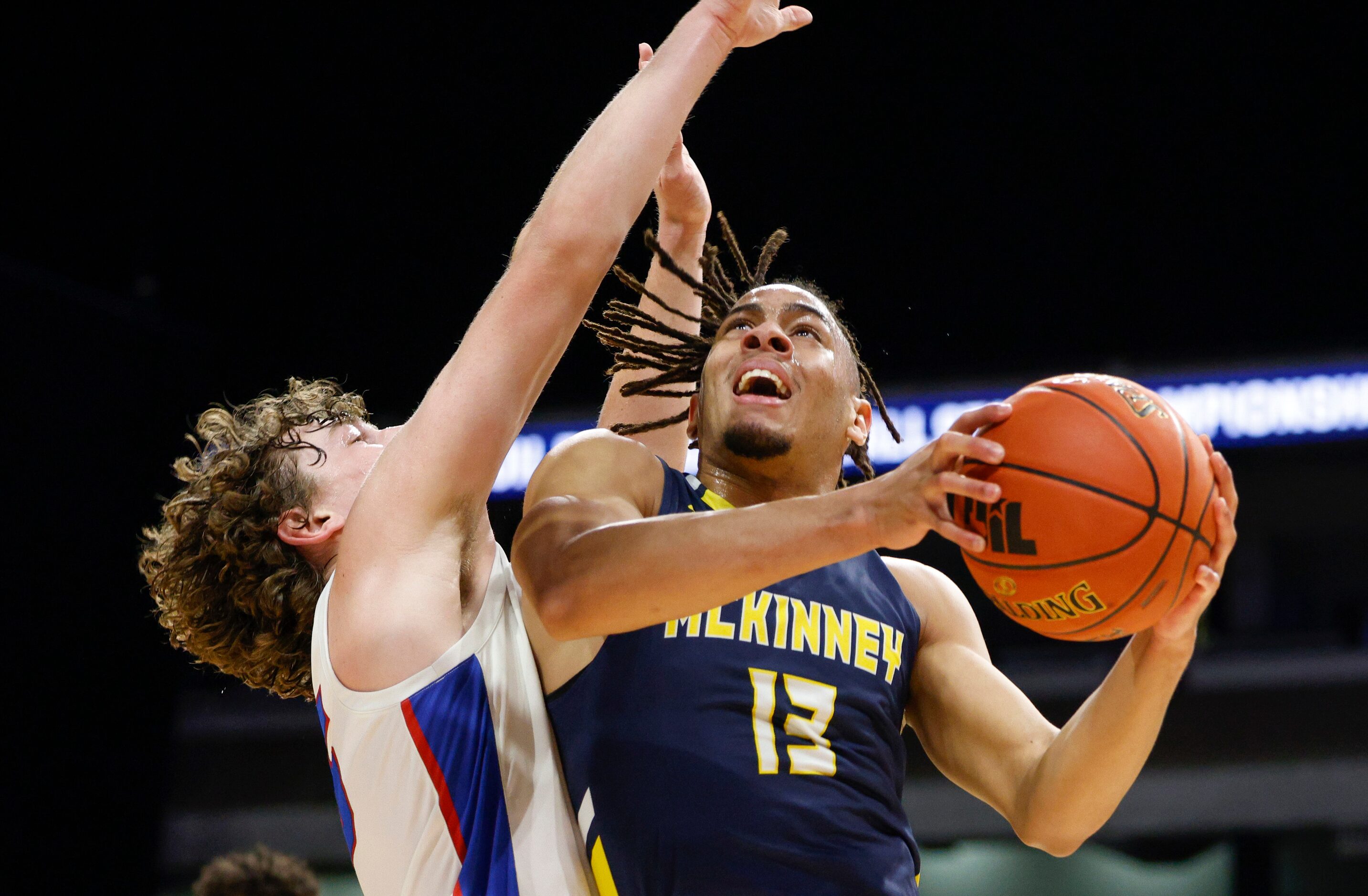 McKinney guard Devin Vincent (13) collides with Austin Westlake guard Conor McManus (35) as...