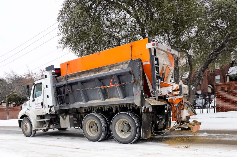 A City of Dallas truck spreads de-icing materials on Walnut Hill Lane near North Central...