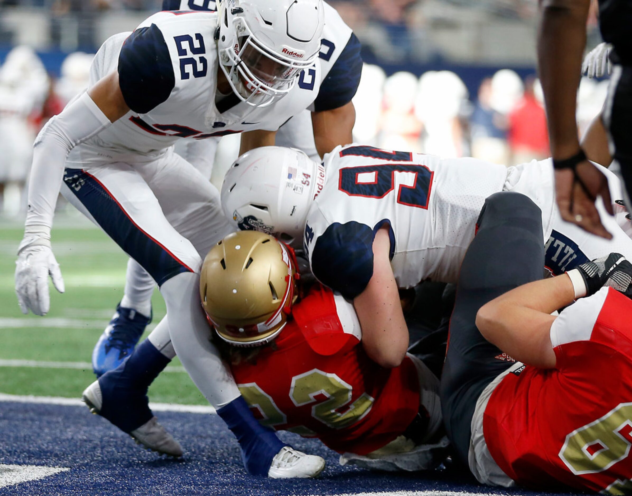 South Grand Prairie's Keodrick Young (22) scores a touchdown as he's tackled by Allen's...