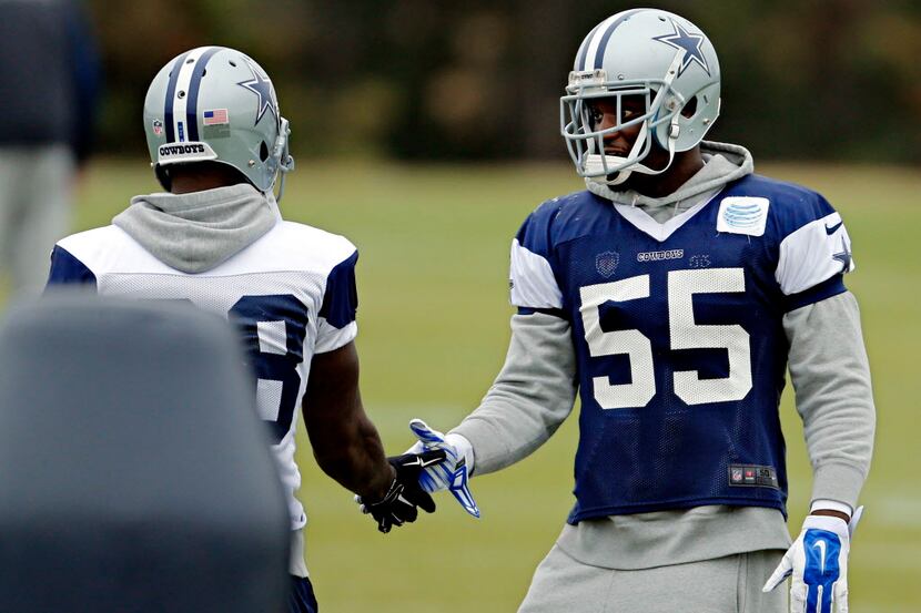 Dallas Cowboys middle linebacker Rolando McClain (55) shakes hands with wide receiver Dez...