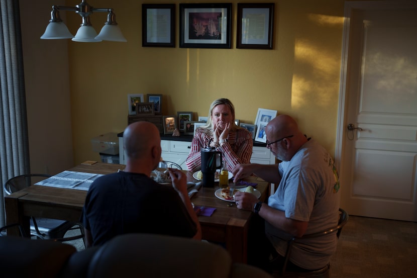 Cari-Ann Burgess, interim Registrar of Voters for Washoe County, Nev., center, eats dinner...