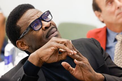 Michael Irvin watches a video of himself and a female staffer from the Renaissance Phoenix...