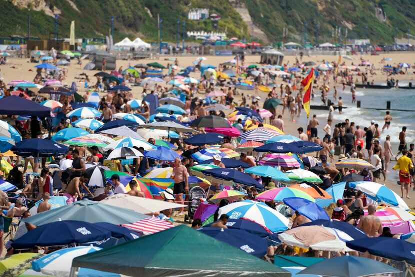 People crowd the beach in Bournemouth, England, Tuesday July 19, 2022. Britain shattered its...