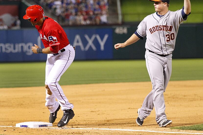 Houston Astros third baseman Matt Dominguez (30) comes away with the tag of Texas Rangers...