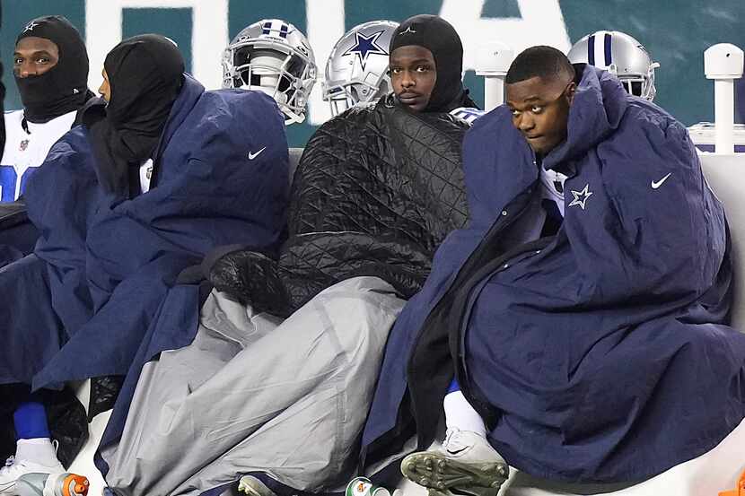 Dallas Cowboys players including wide receiver Amari Cooper (right) and wide receiver CeeDee...