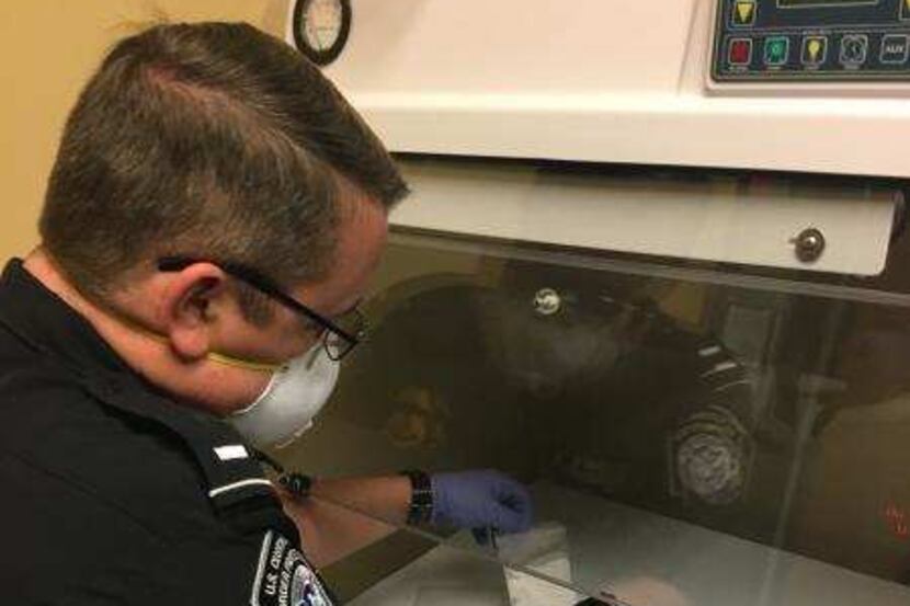 A CBP officer uses the Gemini device to identify an unmarked substance.