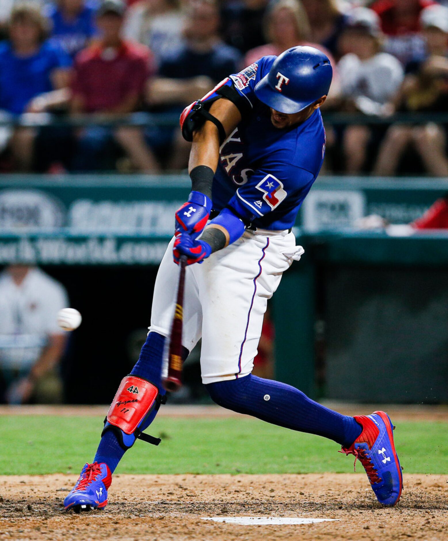 Texas Rangers' Ronald Guzman makes contact for a two-run home run during the eighth inning...