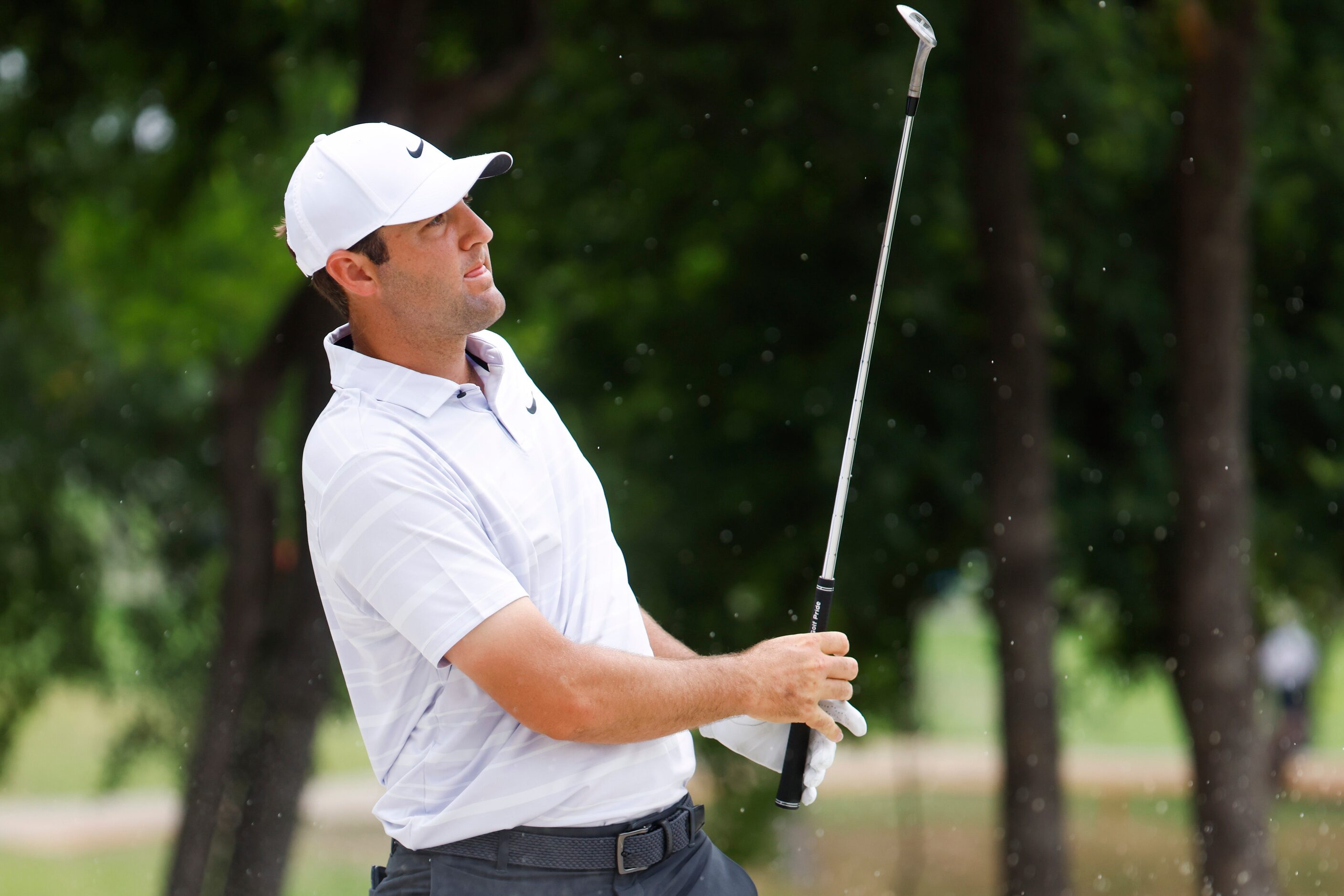 Scottie Scheffler of United States watches as he hits on the eighth hole during the second...