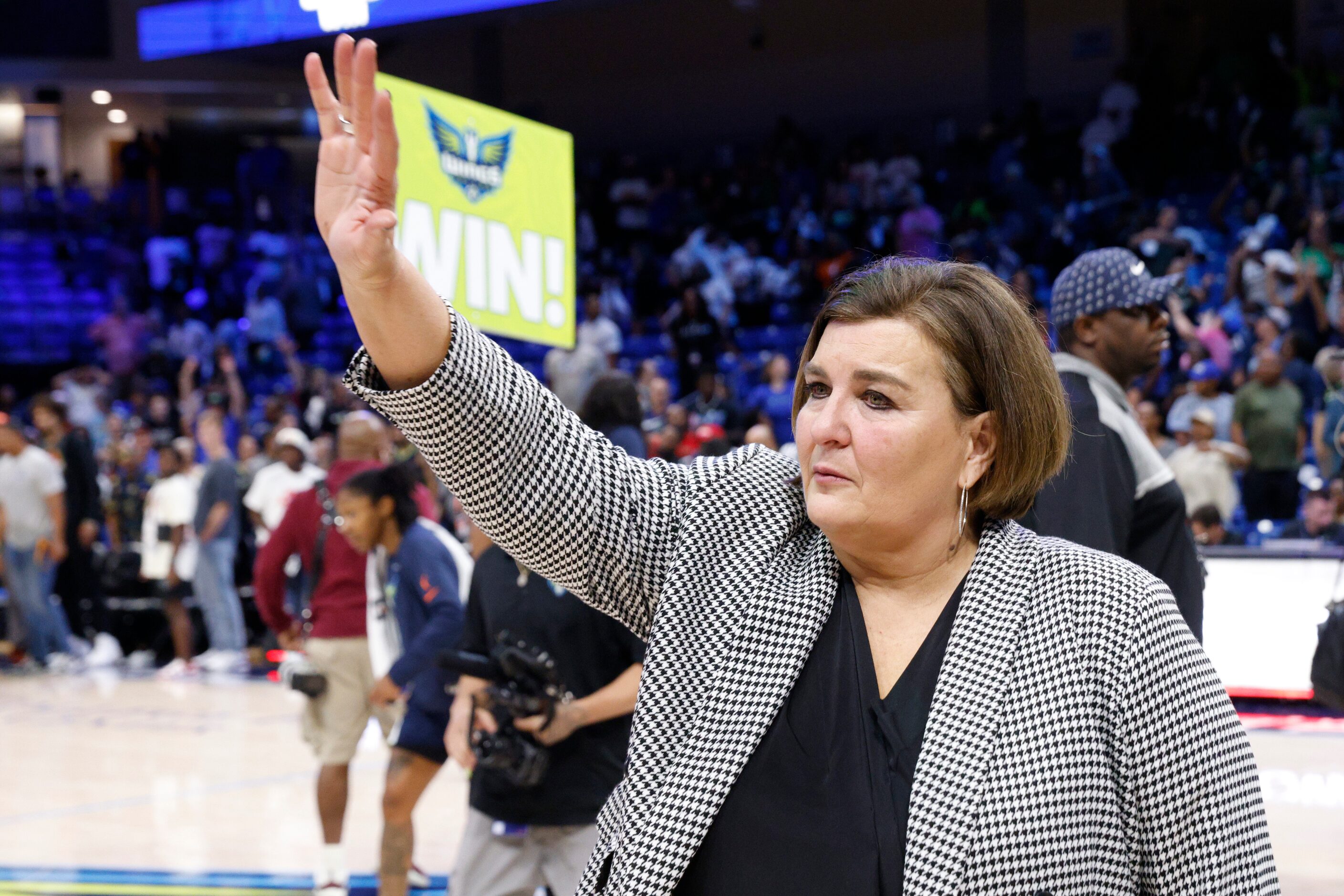 Dallas Wings head coach Latricia Trammell waves to fans after a WNBA first-round playoff...