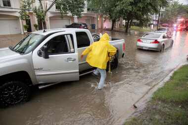 Jose Rivera hops out of his pickup as he asks residents if they need help moving their...