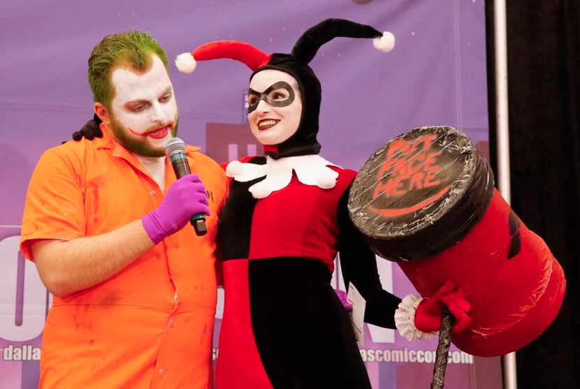 Emcee Ben Ambroso as The Joker and Brandi Dukes as Harley Quinn stay in character for the...