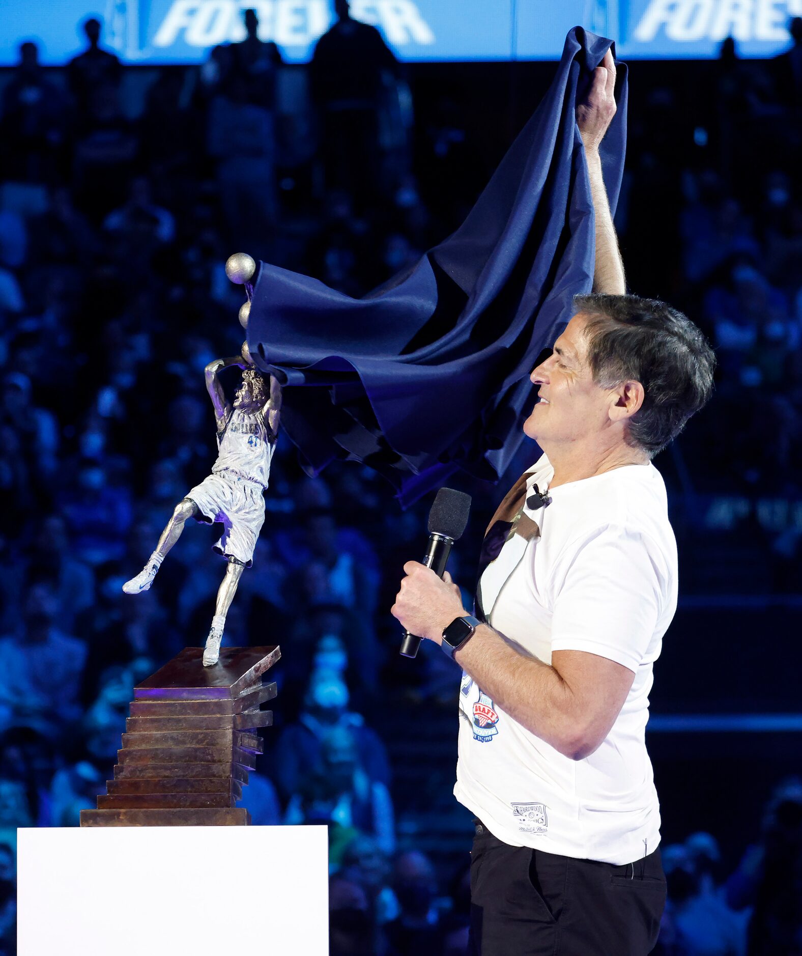 Dallas Mavericks owner Mark Cuban reveals a mini statue of Mavericks All-Star Dirk Nowitzki...