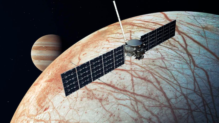 This illustration provided by NASA depicts the Europa Clipper spacecraft over the moon,...