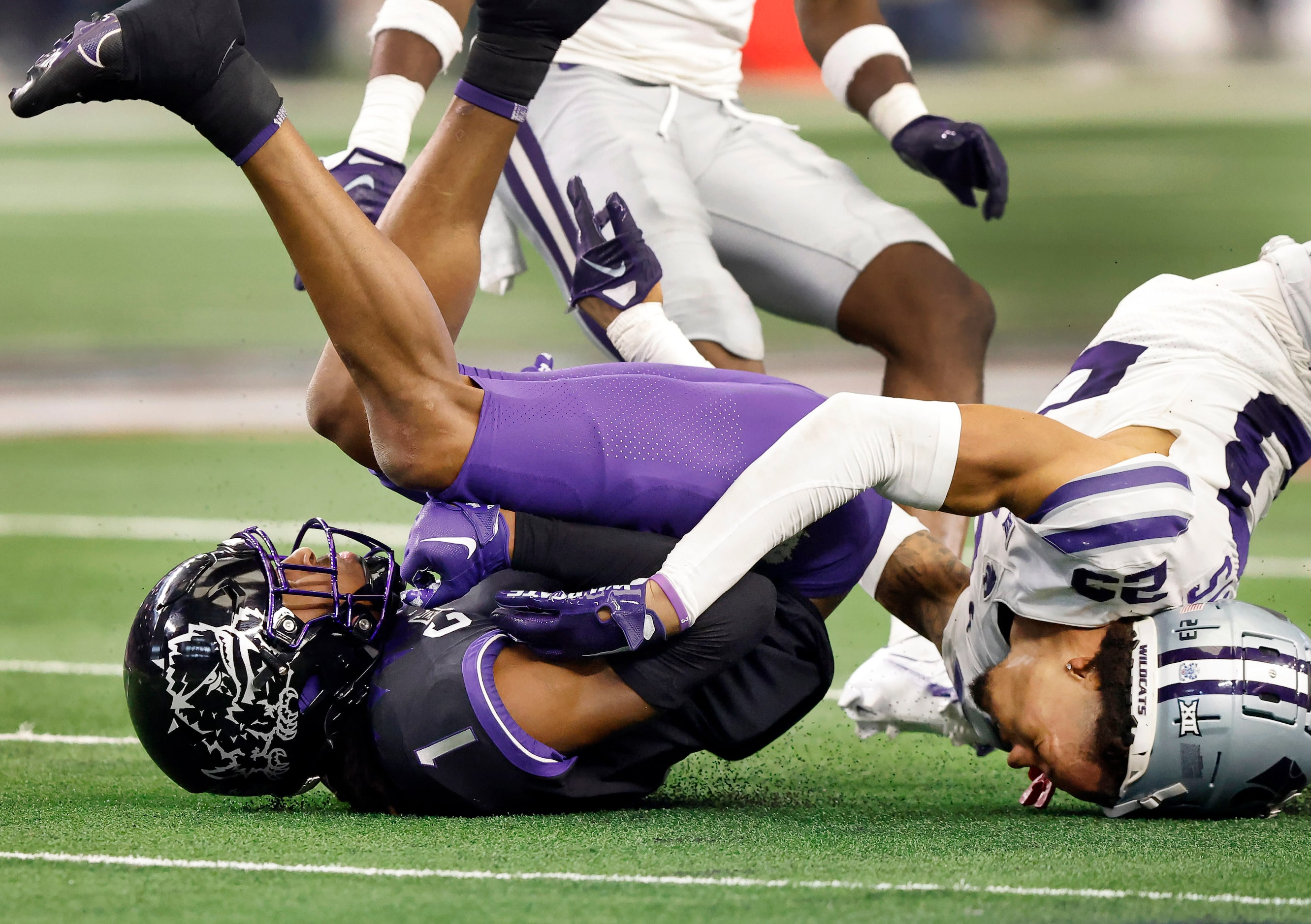 Kansas State Wildcats cornerback Julius Brents’ (23) helmet gets pried off after TCU Horned...