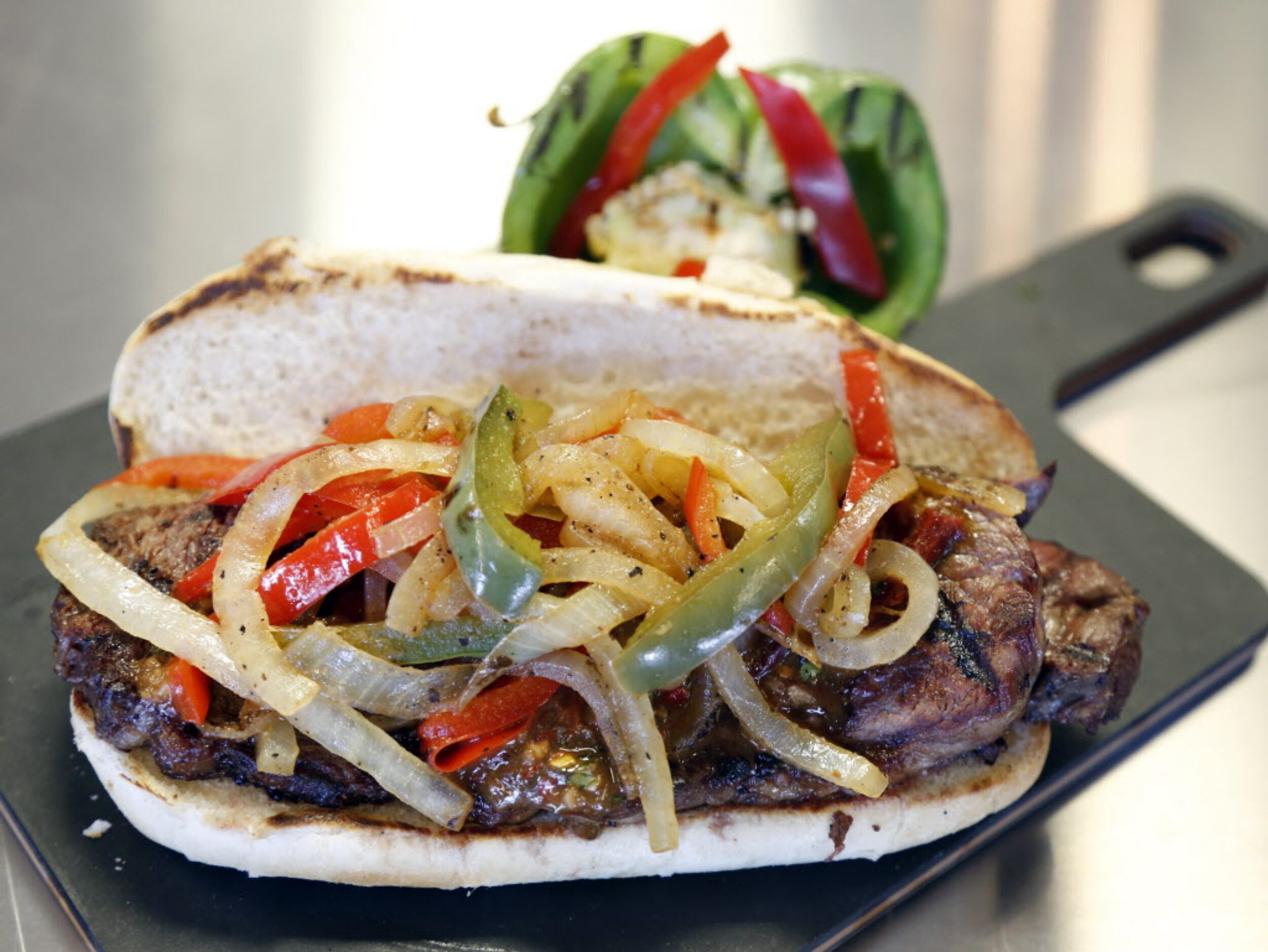 This is the Rio Grande steak sandwich, which is topped with bistro sauce, grilled onions and...