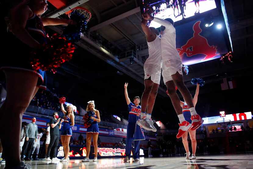 Southern Methodist Mustangs guard Zach Nutall (left) receives a chest bump from teammate...