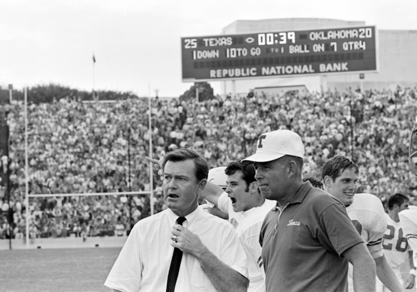 University of Texas head coach Darrell Royal, left, holds back any feeling about his...