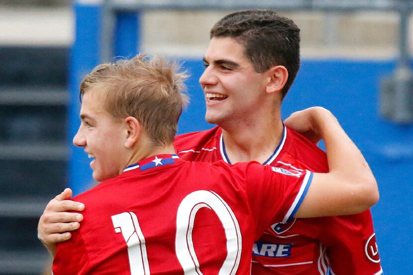 FC Dallas team mates Paxton Pomykal (10) and Adrian Ramos (9) embrace after Pomykal scored...