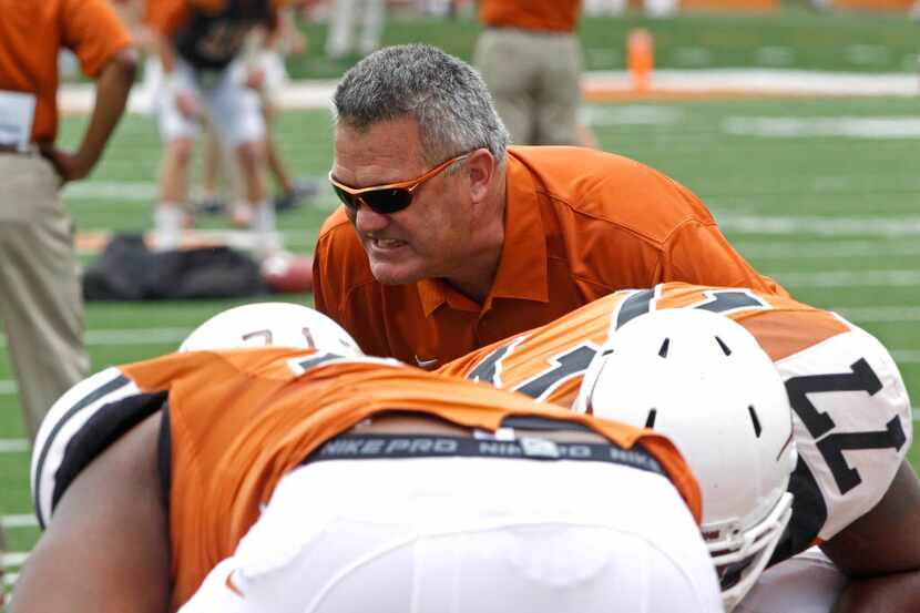 Texas offensive line coach Joe Wickline coaches the linemen before the start of the Orange...