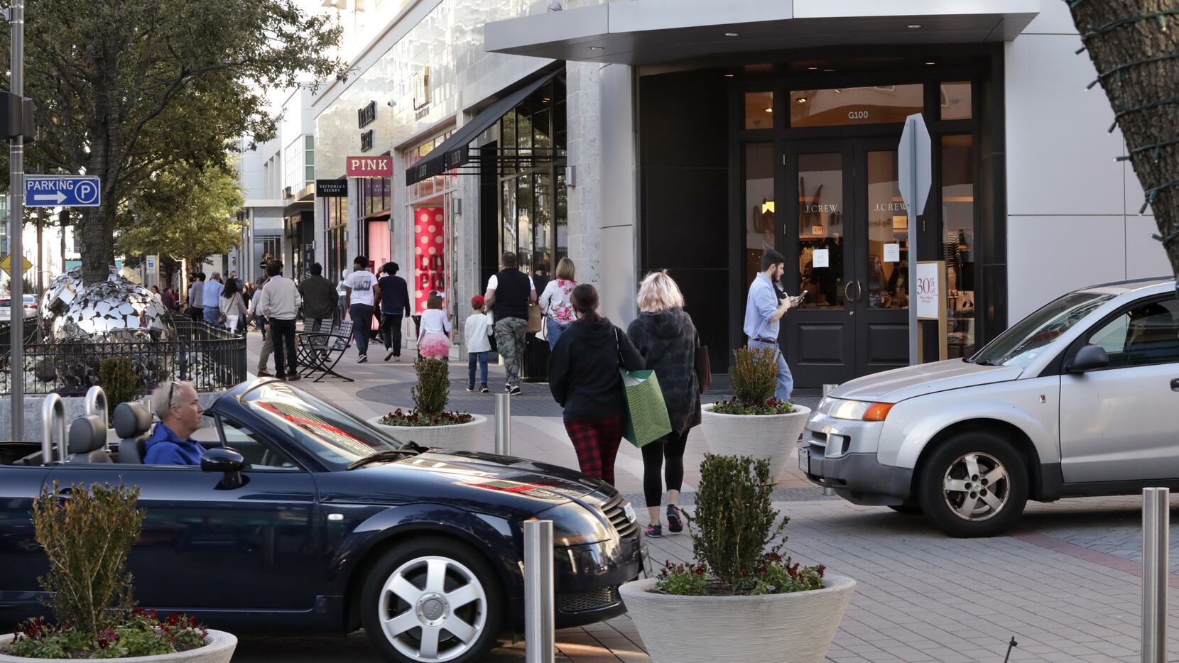 Shoppers stroll along the storefronts at the Legacy West retail center in Plano on Dec. 26.
