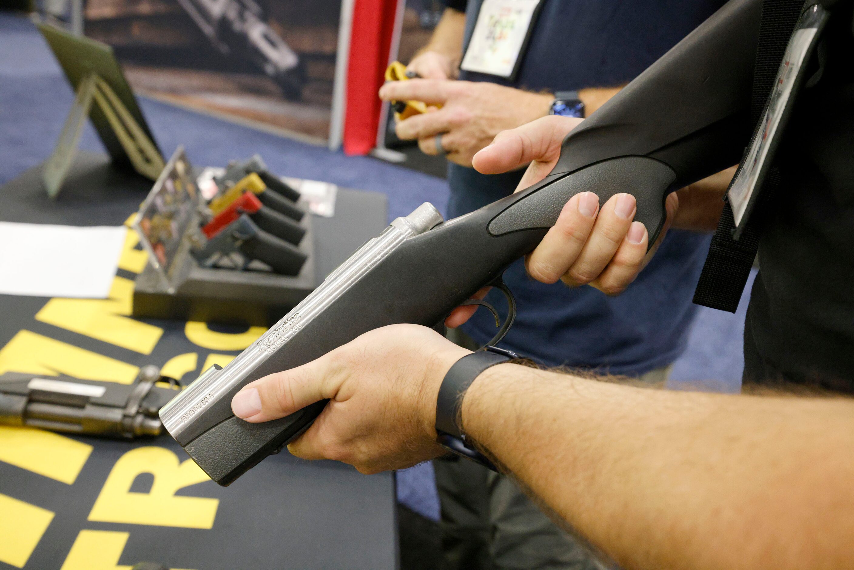 Aaron Thompson of Dallas holds a Remington tester at the Timney Triggers booth, during 2024...