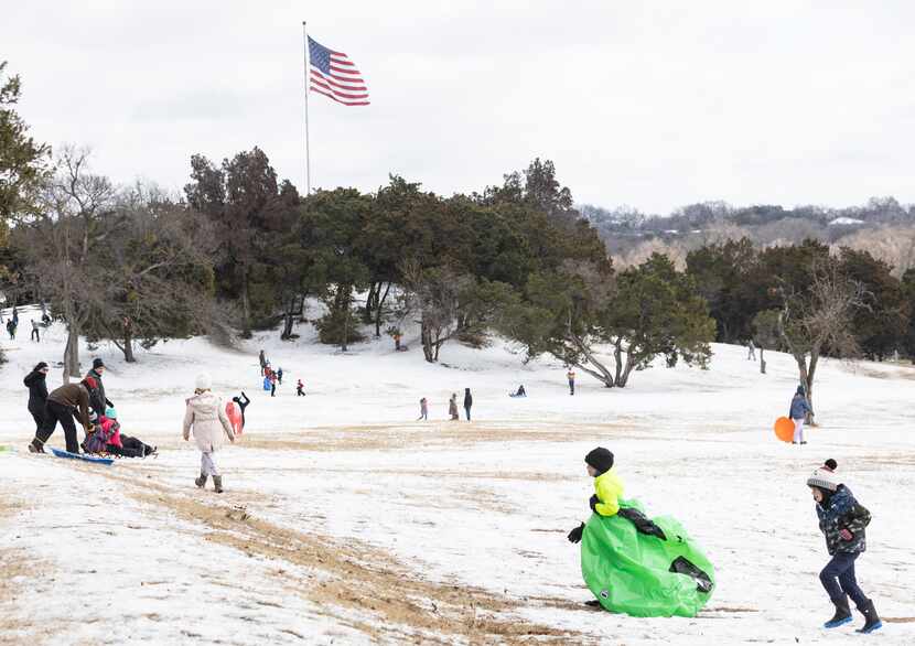 People sled at Flag Pole Hill Park in Dallas on Friday, February 4, 2022. A Hard Freeze...
