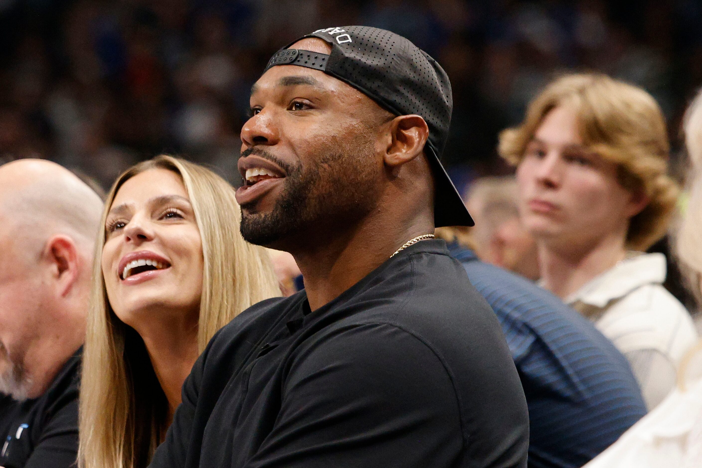 Former NFL player Tyron Smith is seen during the first half of an NBA basketball game...